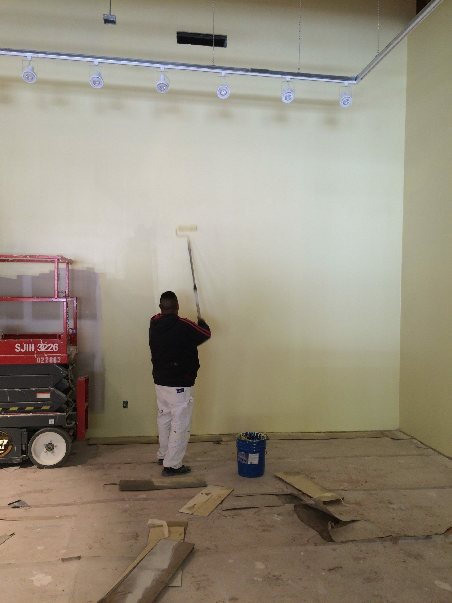 painter painting wall yellow