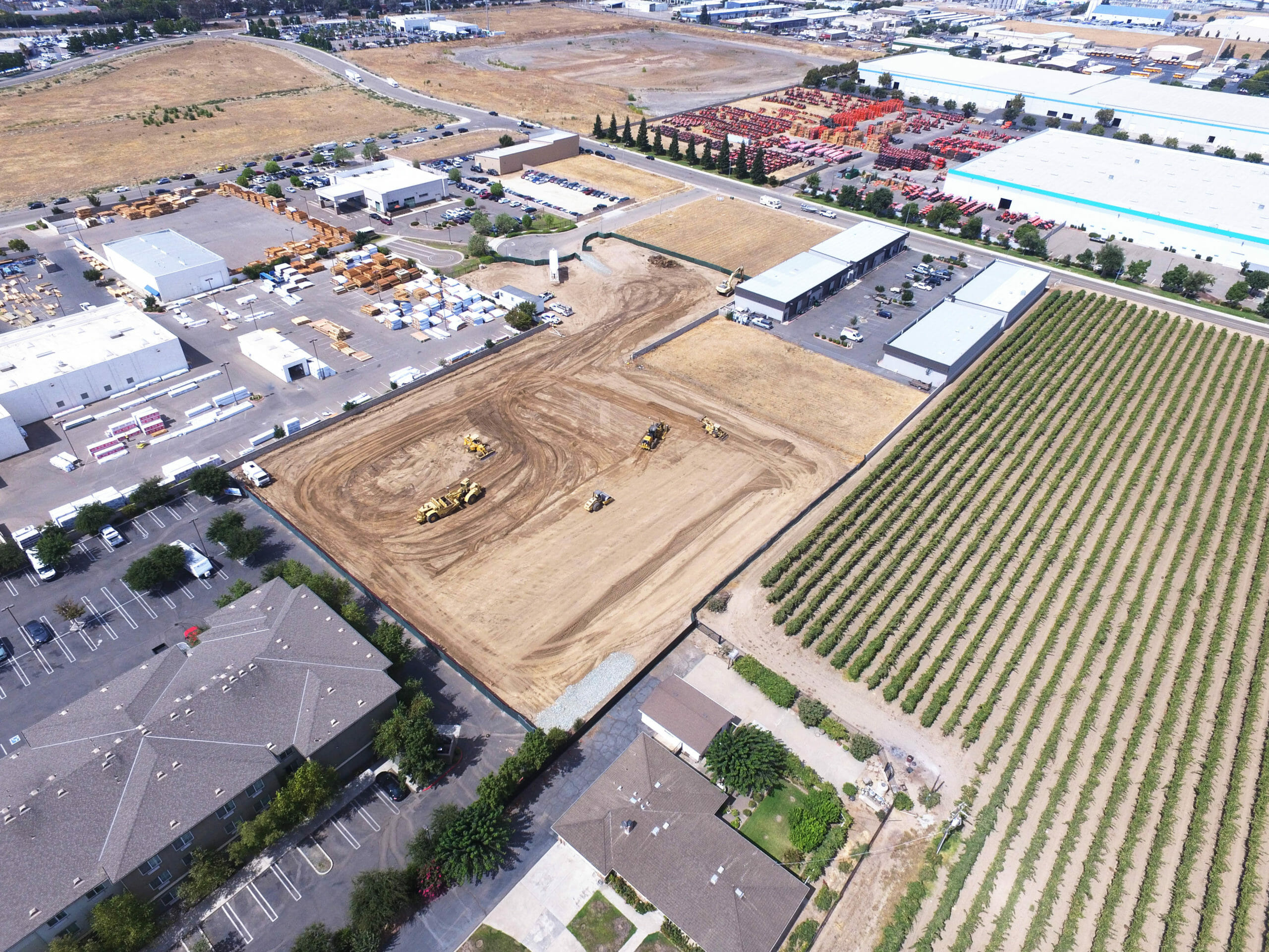 aerial view of trucks grading project site 20 degrees angle