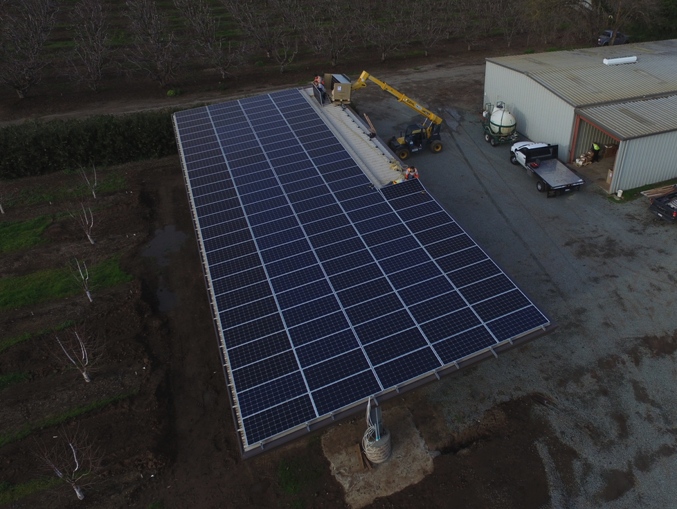 aerial view of solar panels being installed by lifter and workers