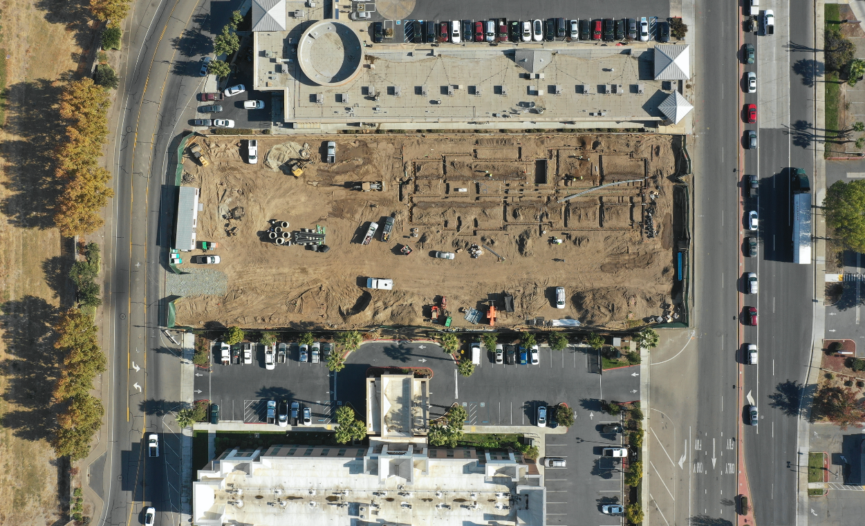 job site drone picture trucks and workers