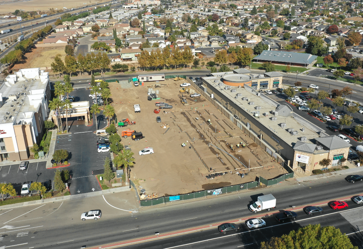 aerial view of trucks grading project site
